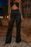 Black satin pants with refined detailing and a flattering silhouette.